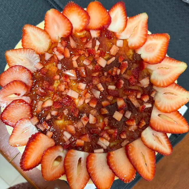 Cheesecake topped with strawberry slices and strawberry compote