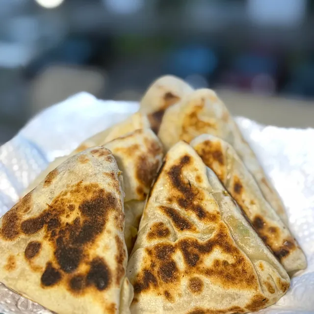 Pan-fried stuffed flatbread triangles